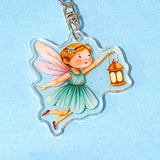 Fairy keychain with a lantern on a light blue background