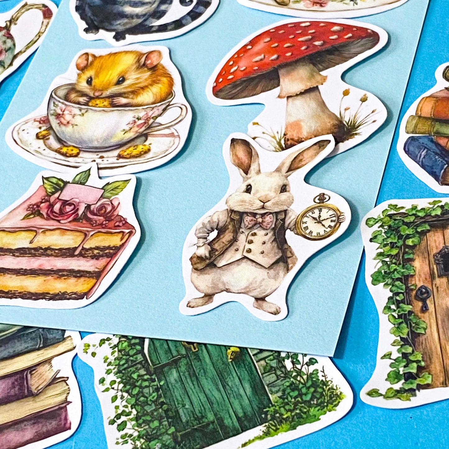 alice in wonderland inspired matte vinyl sticker pack of 20 featuring rabbits, tea cups, dormouse, books, mushroom, potion bottle, whiite rabbit and cheshire cat. uk cute stationery shop and planner supplies.