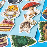 alice in wonderland inspired matte vinyl sticker pack of 20 featuring rabbits, tea cups, dormouse, books, mushroom, potion bottle, whiite rabbit and cheshire cat. uk cute stationery shop and planner supplies.