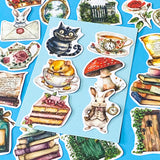 alice in wonderland inspired matte vinyl sticker pack of 20 featuring rabbits, tea cups, dormouse, books, mushroom, potion bottle, whiite rabbit and cheshire cat. uk cute stationery shop and planner supplies.
