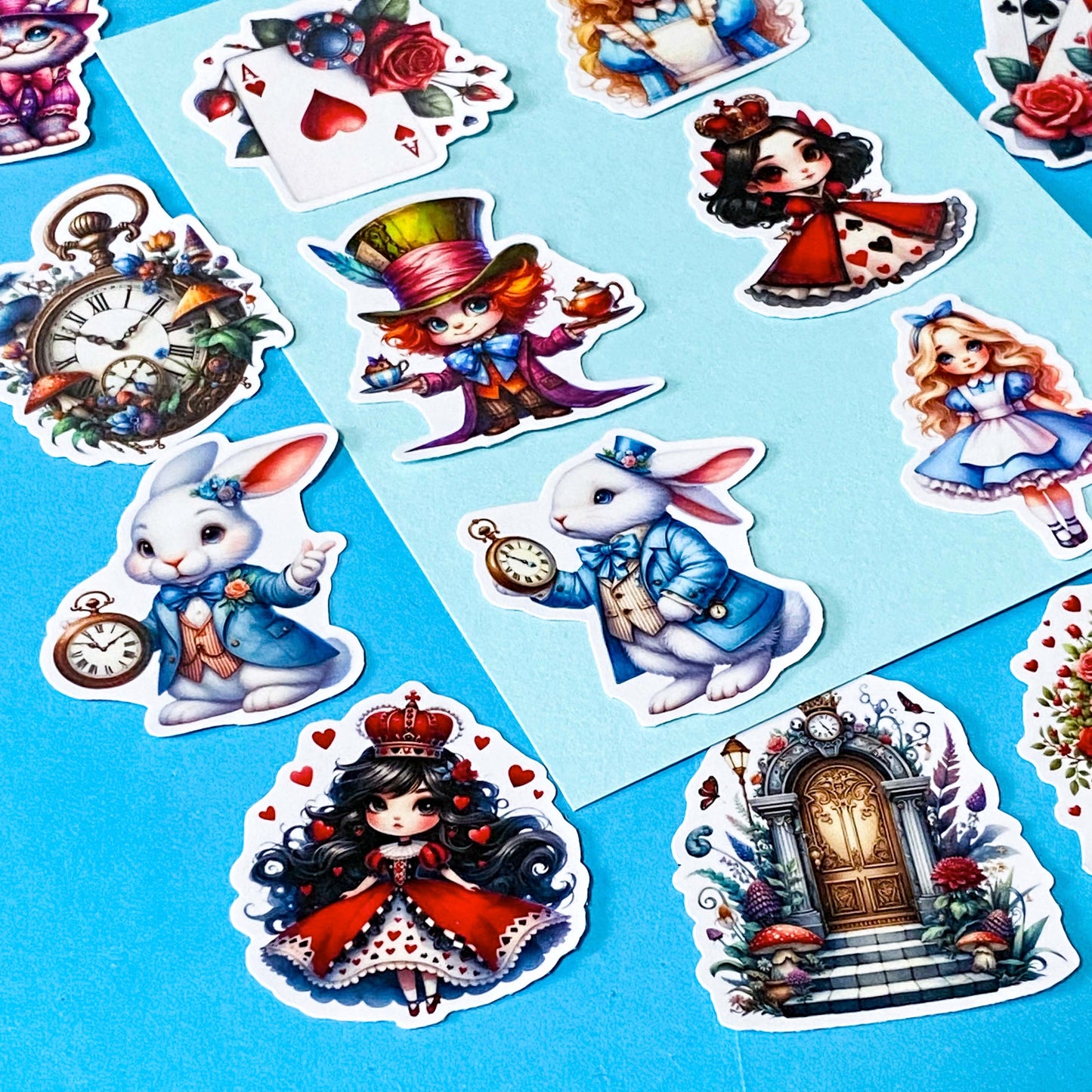 alice in wonderland inspired vinyl satin sticker set of 20 with cute kawaii illustrations featuring mad hatter, cartoon style red queen of hearts, pocket watch, white rabbit, cheshire cat, alice and playing card designs. UK cute stationery and sticker shop.