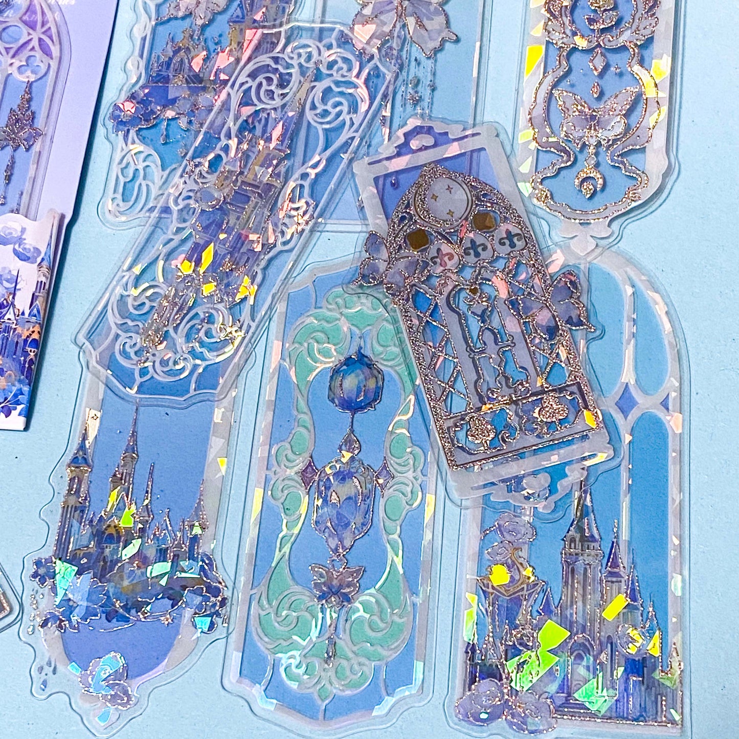 holographic blue window plastic bookmarks with butterflies and princess castles on a blue background