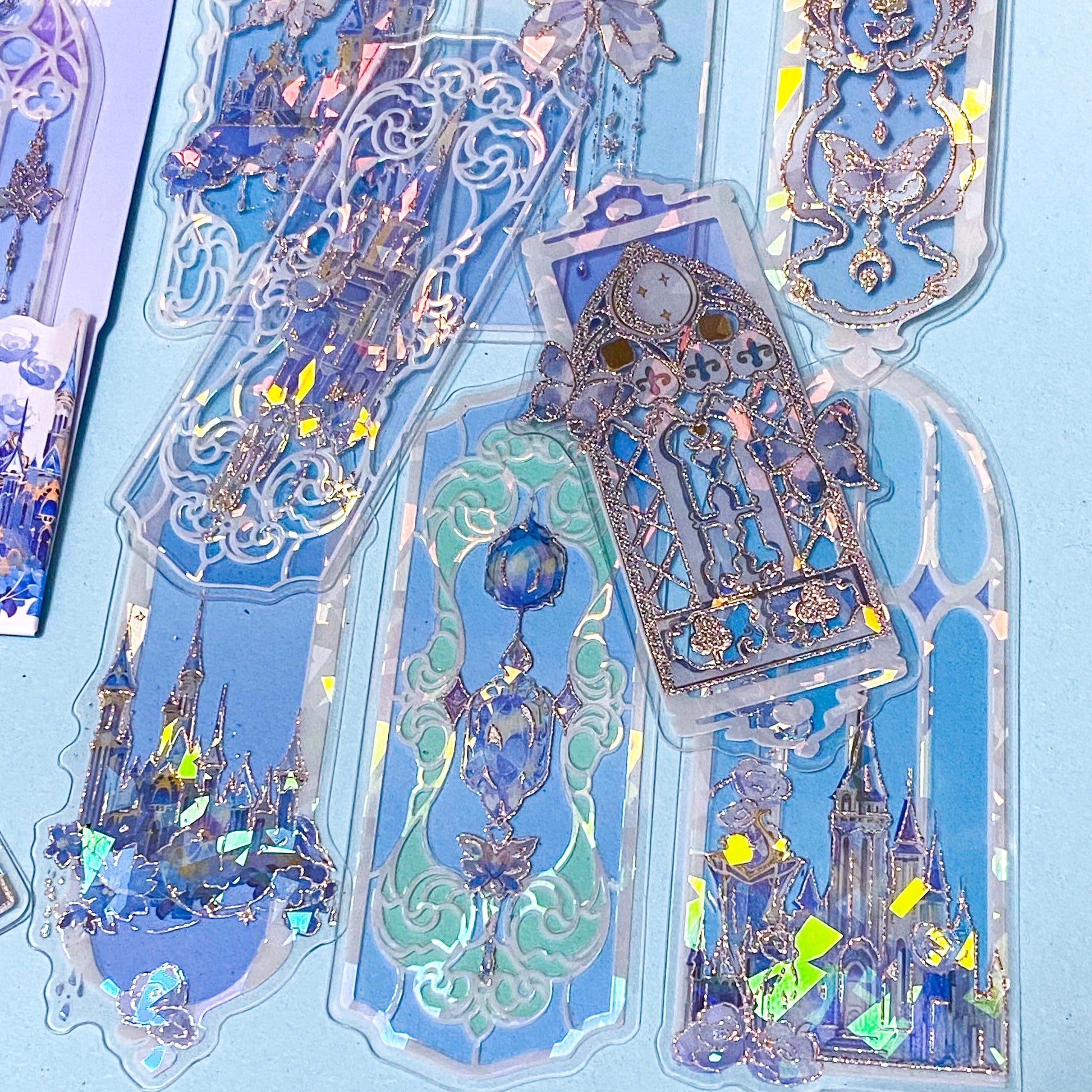 holographic blue window plastic bookmarks with butterflies and princess castles on a blue background