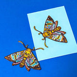 two colourful brown and teal embroidered moth patches that can be ironed on or sewn on. 