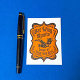vintage style bat wing potion bottle label sticker on a blue background