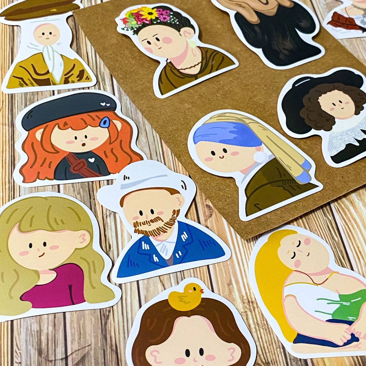 fifty different kawaii portrait art stickers inspired by famous artists, masterpieces and historical figures with matte finish, each measuring up to 70mm tall. designs include mona lisa, the scream, birth of venus, frieda kahlo, matisse, van gogh
