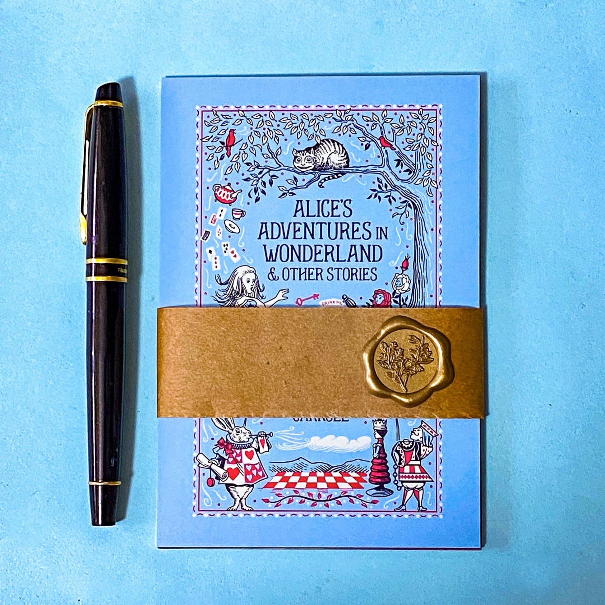 set of 5 vintage literary postcards featuring fairytale book covers including Alice in Wonderland, Wizard of Oz and Grimm Fairy Stories wrapped in a kraft belly band with a wax seal sticker