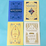 Four book cover postcards of 'Middlemarch', 'Les Miserables', 'Selected Poems of Emily Dickinson', and 'The Great Gatsby' on a blue background.