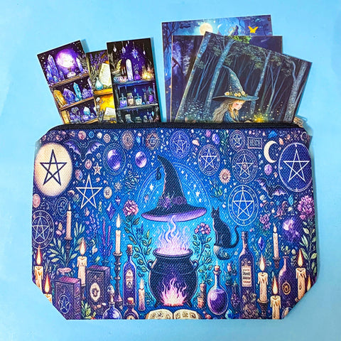 witchy canvas pouch with magical illustration filled with fantasy postcards and bookmarks on blue background