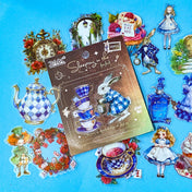 wonderland themed pack of 40 clear PET stickers with Alice illustrations, white rabbits, potion bottles, cupcakes, tea party, teacup, teapot, mad hatter, roses and pocket watches. Uk cute kawaii stationery shop.