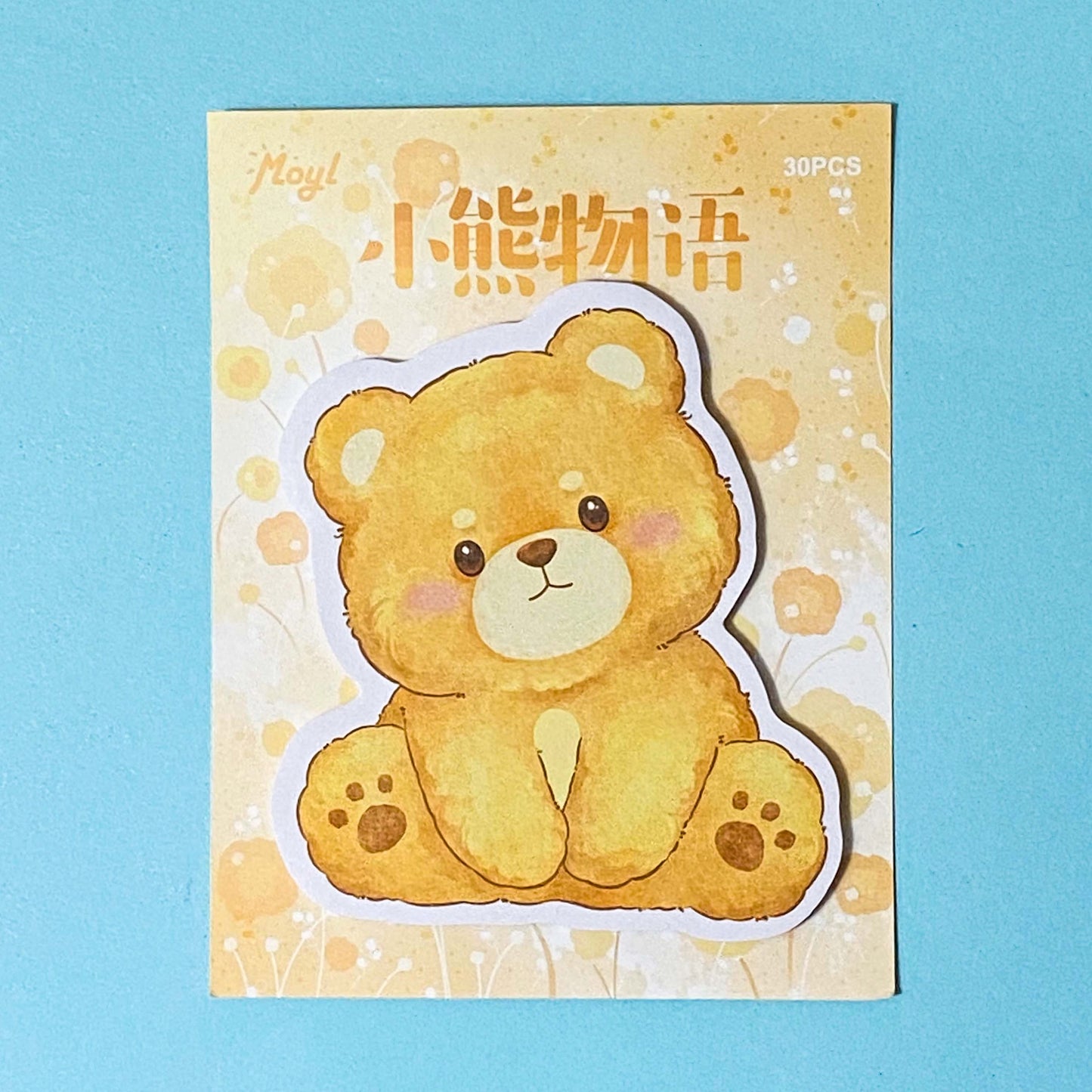teddy bear sticky memo notes pad on a blue background