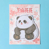 Panda-shaped sticky memo notes pad on a floral background