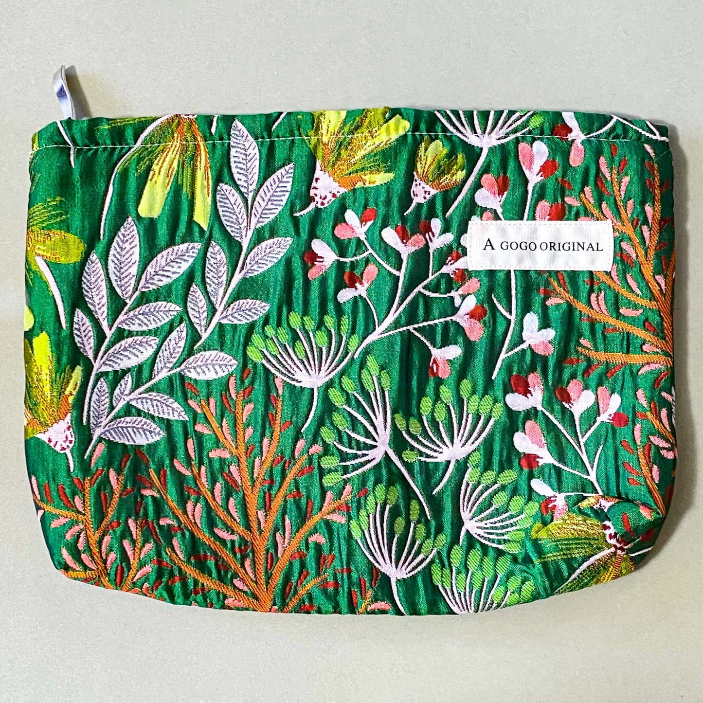 emerald conservatory tapestry pouch featuring a woven satin botanical design in emerald green, coral pink and cream with concealed zip fastening and cream lined interior. Uk luxury letterbox gifts shop. 