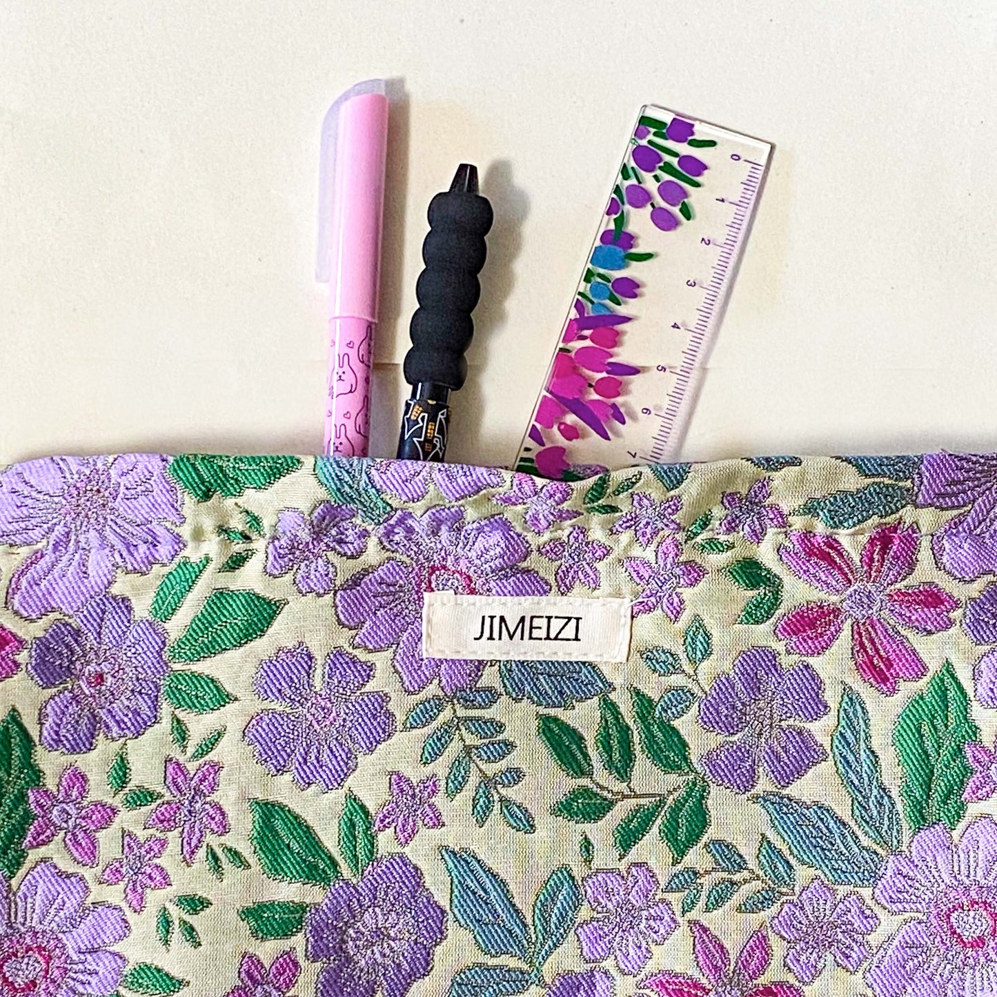 lilac cottage garden tapestry pouch with woven floral fabric in shades of lavender, purple, turquoise and green, fully lined with concealed zip fastening. Uk letterbox gifts. Beautiful quality cosmetic bags.