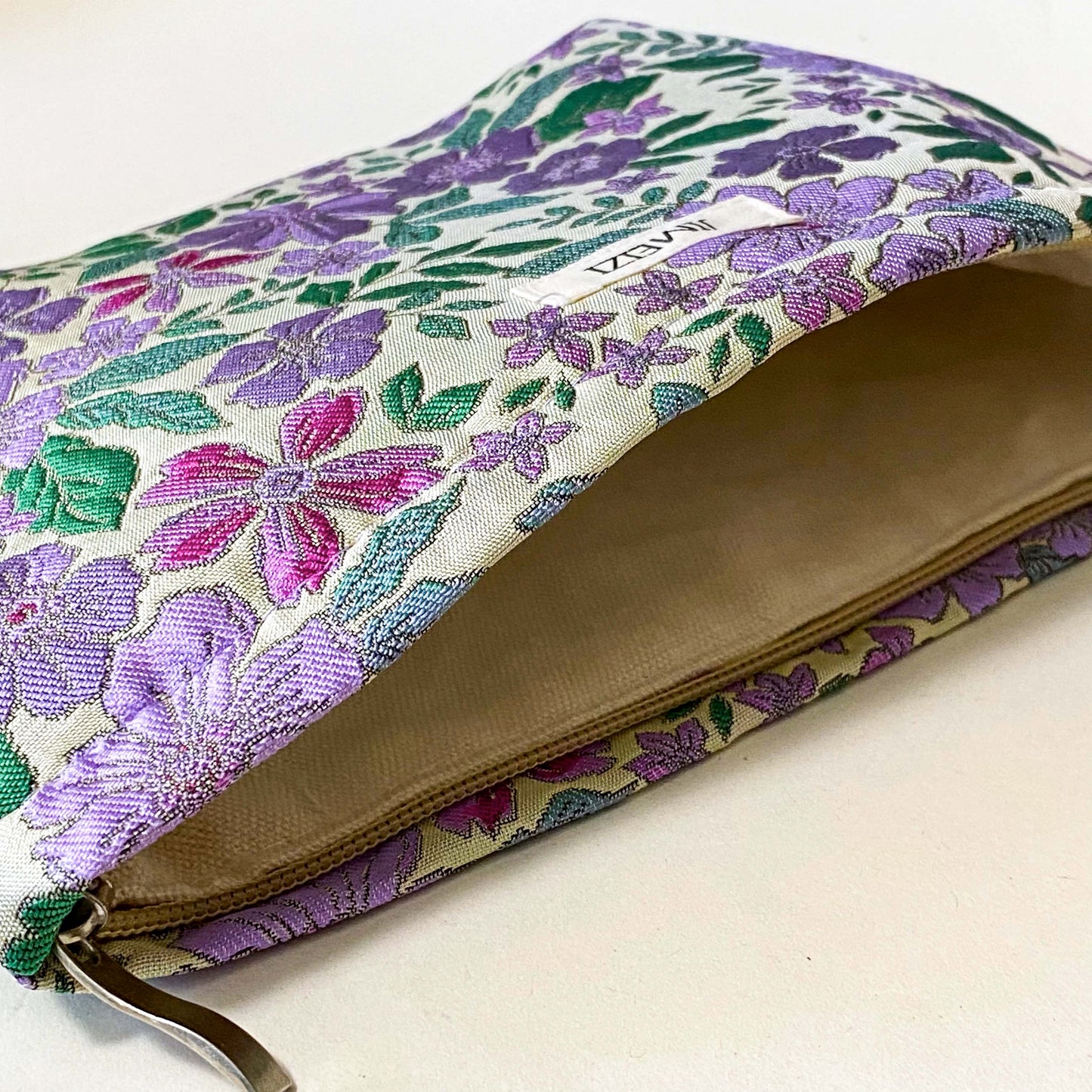 lilac cottage garden tapestry pouch with woven floral fabric in shades of lavender, purple, turquoise and green, fully lined with concealed zip fastening. Uk letterbox gifts. Beautiful quality cosmetic bags.