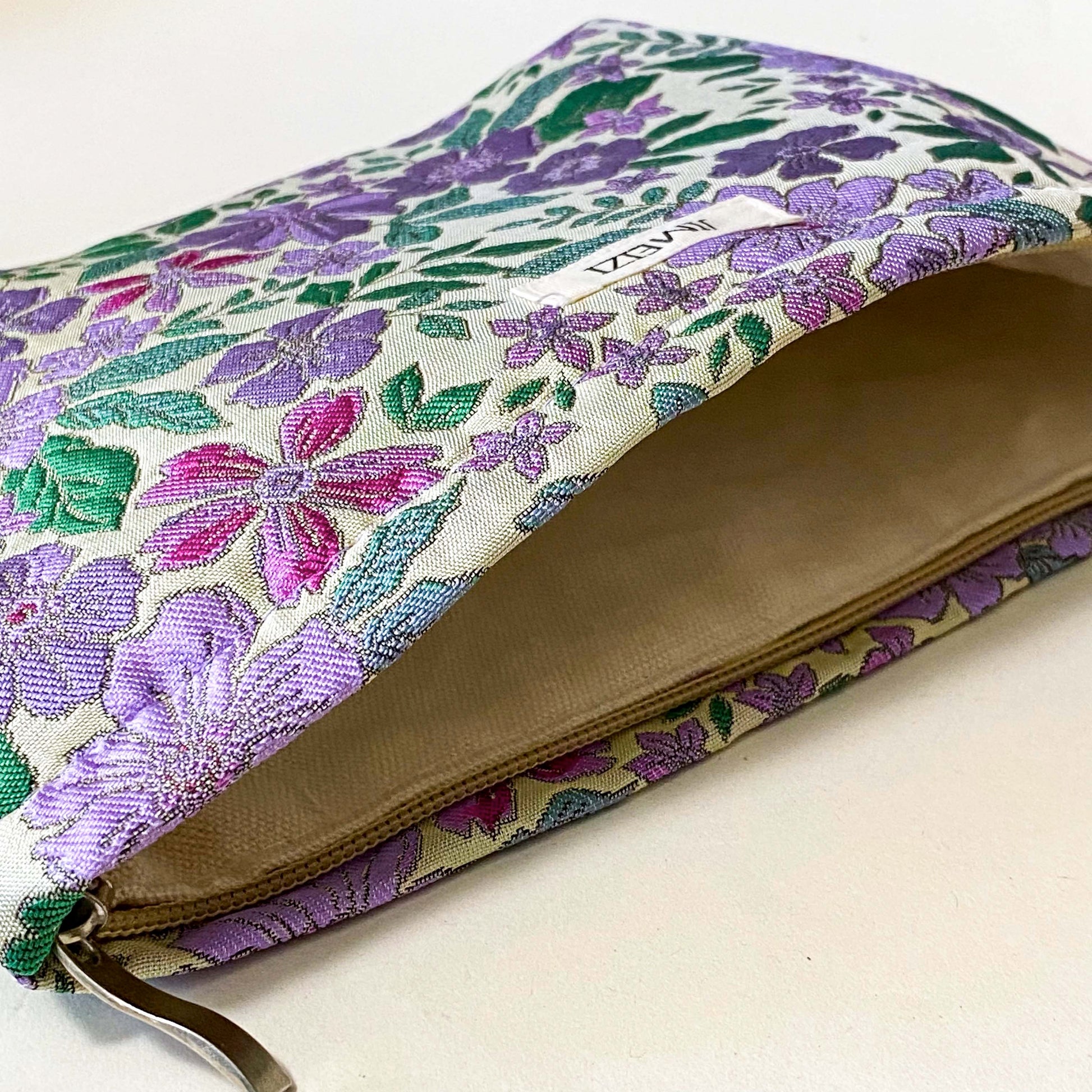 lilac cottage garden tapestry pouch with woven floral fabric in shades of lavender, purple, turquoise and green, fully lined with concealed zip fastening. Uk letterbox gifts. Beautiful quality cosmetic bags.