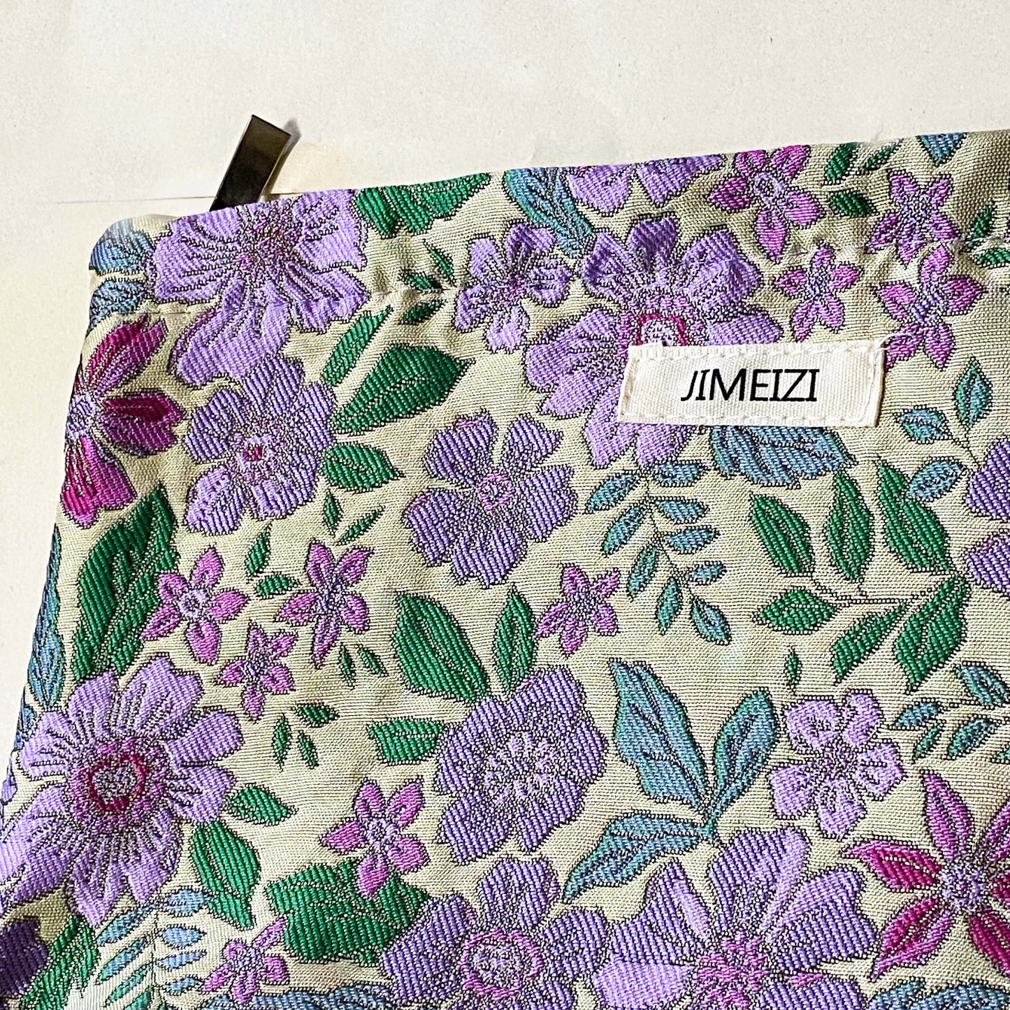 lilac cottage garden tapestry pouch with woven floral fabric in shades of lavender, purple, turquoise and green, fully lined with concealed zip fastening. Uk letterbox gifts. Beautiful quality cosmetic bags.