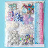 craft kit with a celestial space theme including beads, charms, flatbacks and grosgrain ribbon in a cellophane pack on a blue background