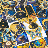 set of 50 dark celestial aesthetic stickers featuring stars, moons, planets, botanical illustrations and mystical designs in deep blue and gold tones
