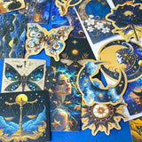 set of 50 dark celestial aesthetic stickers featuring stars, moons, planets, botanical illustrations and mystical designs in deep blue and gold tones