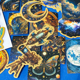 set of 50 dark celestial aesthetic stickers featuring stars, moons, planets, botanical illustrations and mystical designs in deep blue and gold tones