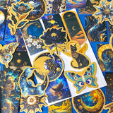 set of 50 dark celestial aesthetic stickers featuring stars, moons, planets, botanical illustrations and mystical designs in deep blue and gold tones