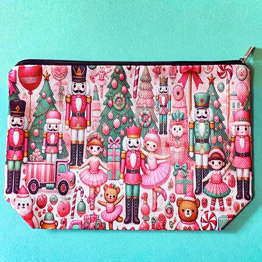 pink woven christmas zip canvas pouch featuring nutcrackers, ballerinas, trees, bears, festive gifts and toys. uk letterbox gifts. cosmetic bag.