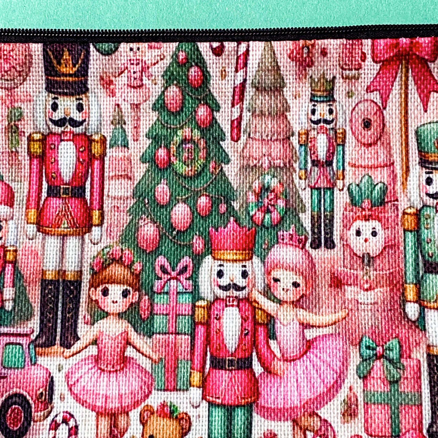 pink woven christmas zip canvas pouch featuring nutcrackers, ballerinas, trees, bears, festive gifts and toys. uk letterbox gifts. cosmetic bag.