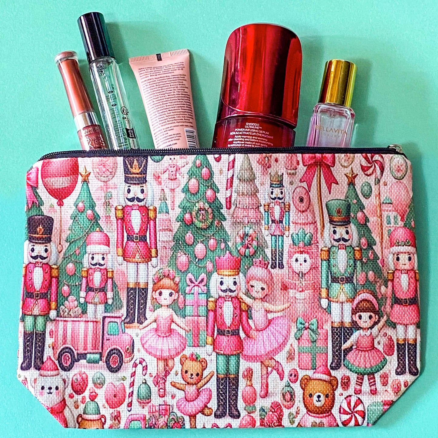 pink woven christmas zip canvas pouch featuring nutcrackers, ballerinas, trees, bears, festive gifts and toys. uk letterbox gifts. cosmetic bag.