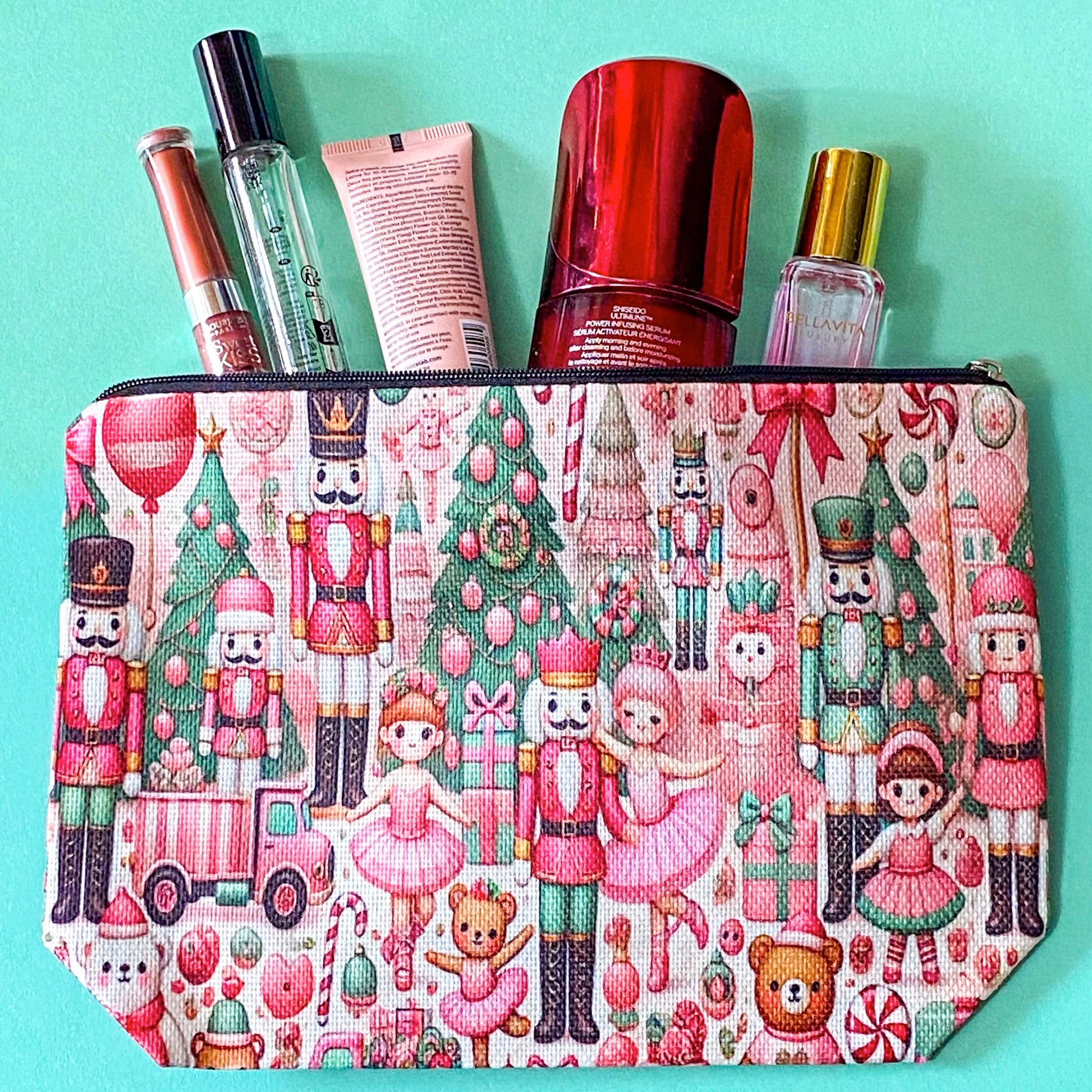 pink woven christmas zip canvas pouch featuring nutcrackers, ballerinas, trees, bears, festive gifts and toys. uk letterbox gifts. cosmetic bag.