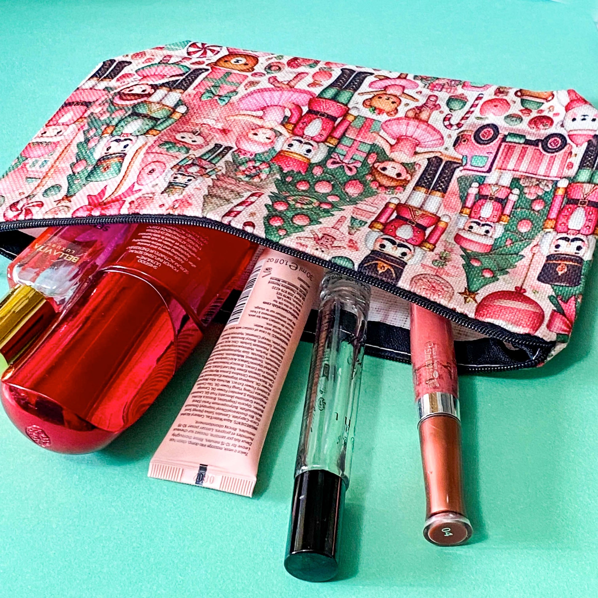 pink woven christmas zip canvas pouch featuring nutcrackers, ballerinas, trees, bears, festive gifts and toys. uk letterbox gifts. cosmetic bag.