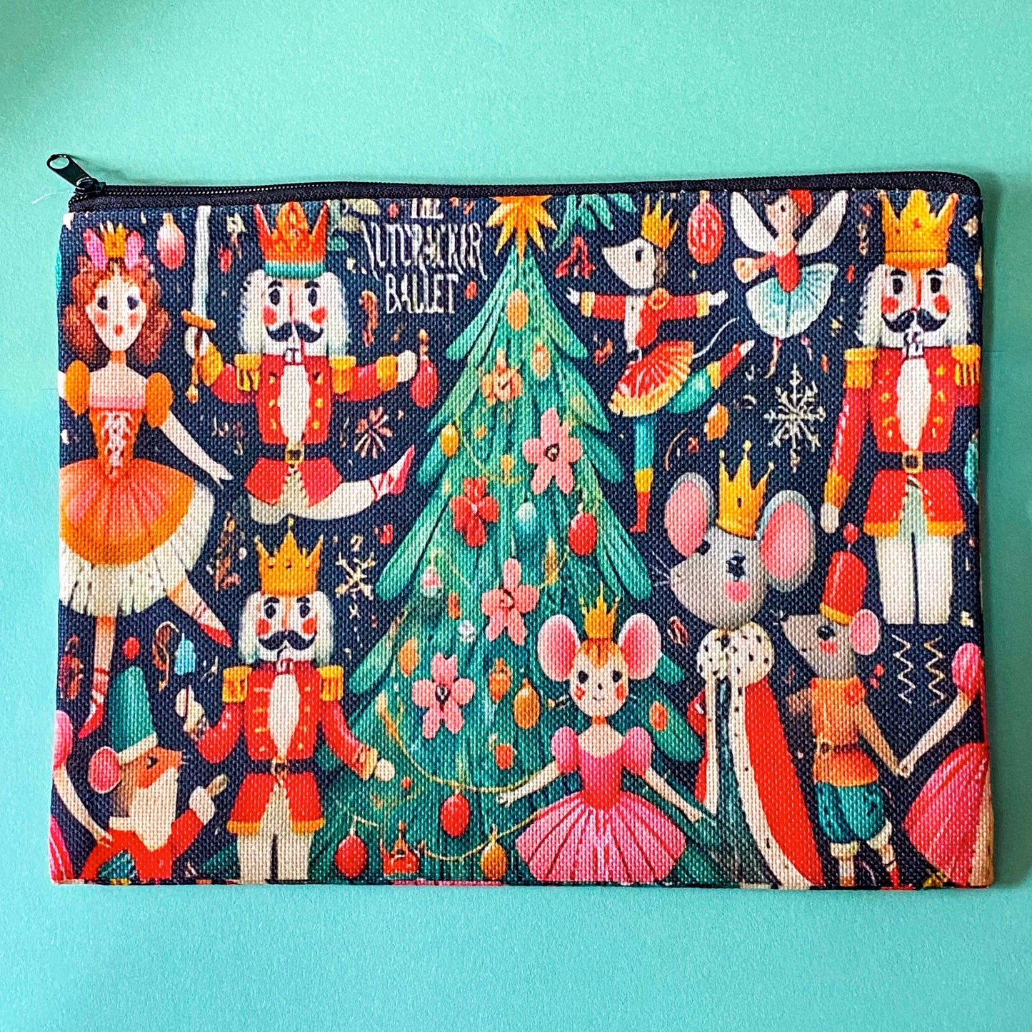 large woven nutcracker ballet zip canvas pouch featuring ballerinas, royal nutcrackers, dancing mice, a decorated Christmas tree and festive illustrations on black background