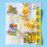 craft bundle in a bee and daisy theme with grosgrain ribbon, buttons, flatbacks, charms and beads on a blue background