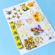 craft bundle in a bee and daisy theme with grosgrain ribbon, buttons, flatbacks, charms and beads on a blue background
