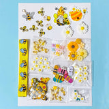 craft bundle in a bee and daisy theme with grosgrain ribbon, buttons, flatbacks, charms and beads on a blue background
