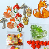 autumn fox craft bundle with grosgrain ribbon, beads, enamel charms, sequins and buttons in a cellophane pack on a white background