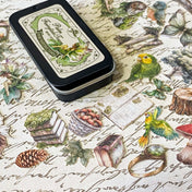 mini tin of 60 card stickers in an enchanted forest theme with mushrooms, berries, birds, books, butterflies, tree stumps and diamond rings