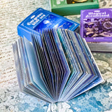 open mini paper book showing scrapbook paper and translucent vellum sheets in blue ocean tones