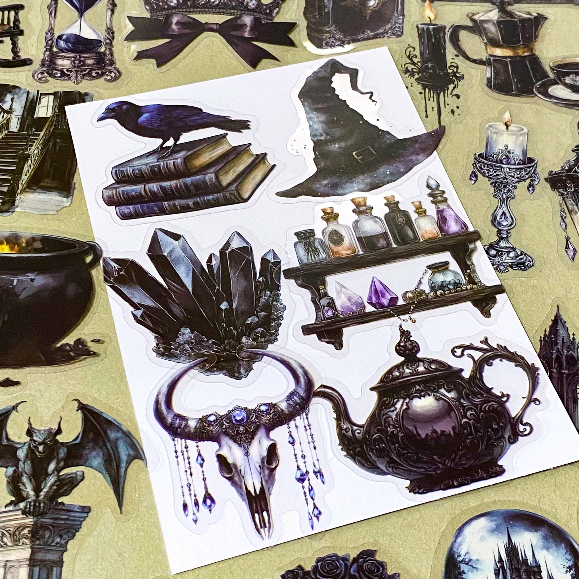 shadow gothic black and dark academia witchy gothic pet stickers pack of 50 with candles, ravens, black cats, hats, crystals, teapots, bats, griffins, potions, spell books. large 70mm clear plastic sticker pack.