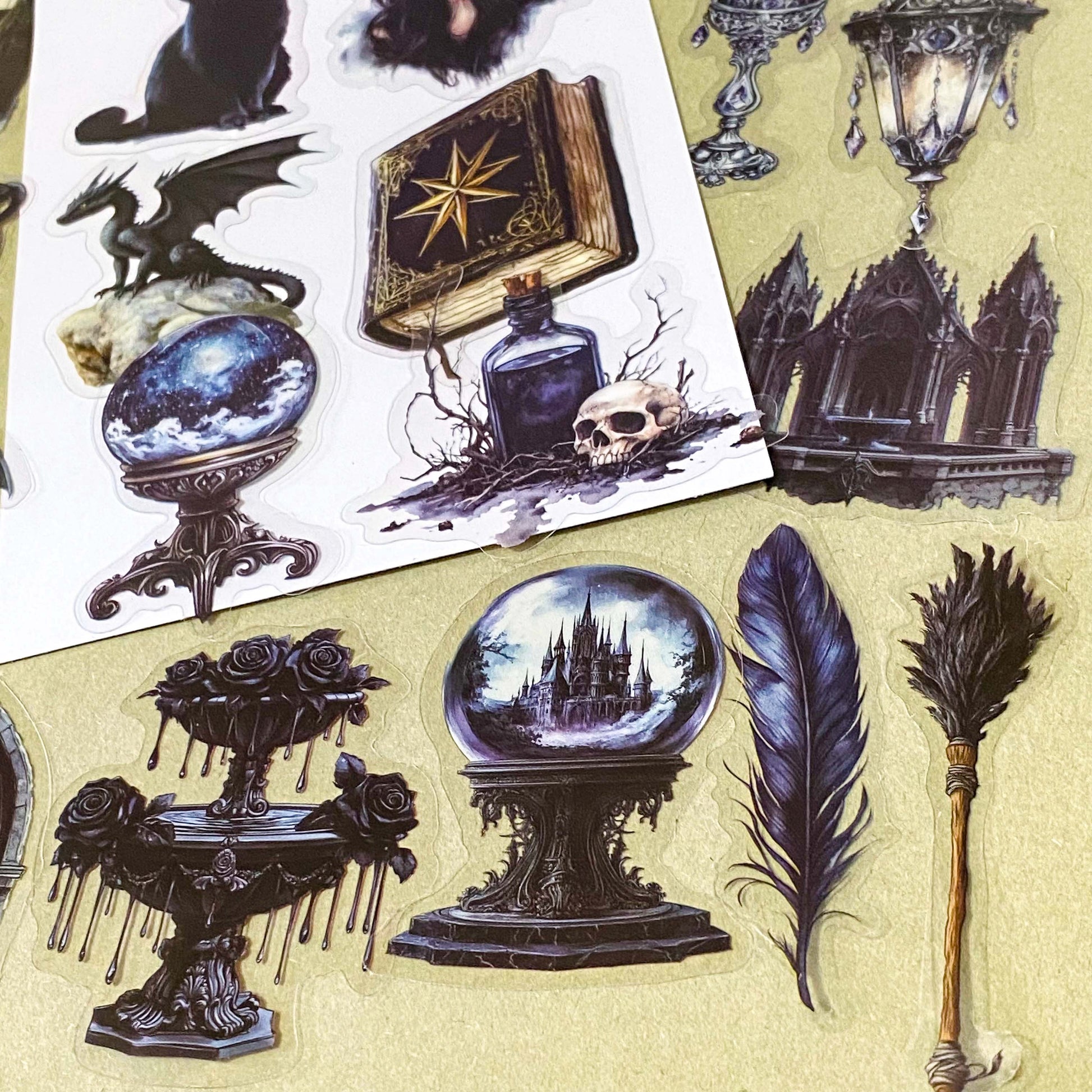 shadow gothic black and dark academia witchy gothic pet stickers pack of 50 with candles, ravens, black cats, hats, crystals, teapots, bats, griffins, potions, spell books. large 70mm clear plastic sticker pack.