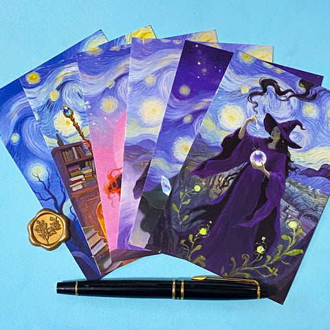 set of 6 dark fantasy postcards featuring wizard, witch, cloaked figures and starry night skies in deep blue and purple tones. arranged with pen for scale