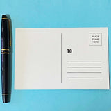 set of 4 fantasy postcards featuring mythical creatures including winged lion and unicorn with celestial skies, wrapped in kraft belly band with wax seal