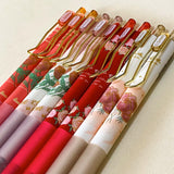set of floral gel pens 0.5mm nib with vintage rose and botanical designs in red, pink and cream tones with gold clips