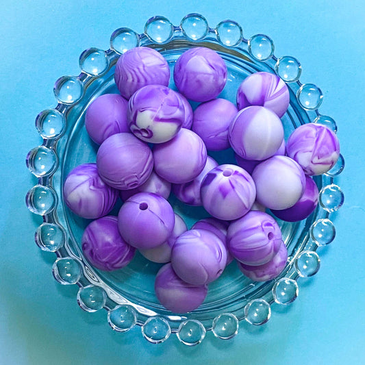 round soft 16mm silicone beads with a marbled pattern of lilac purple and white swirls.