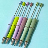 spring meadow pen bases and blanks in botanical colours including green lilac sage and dusky plum on a pale blue background