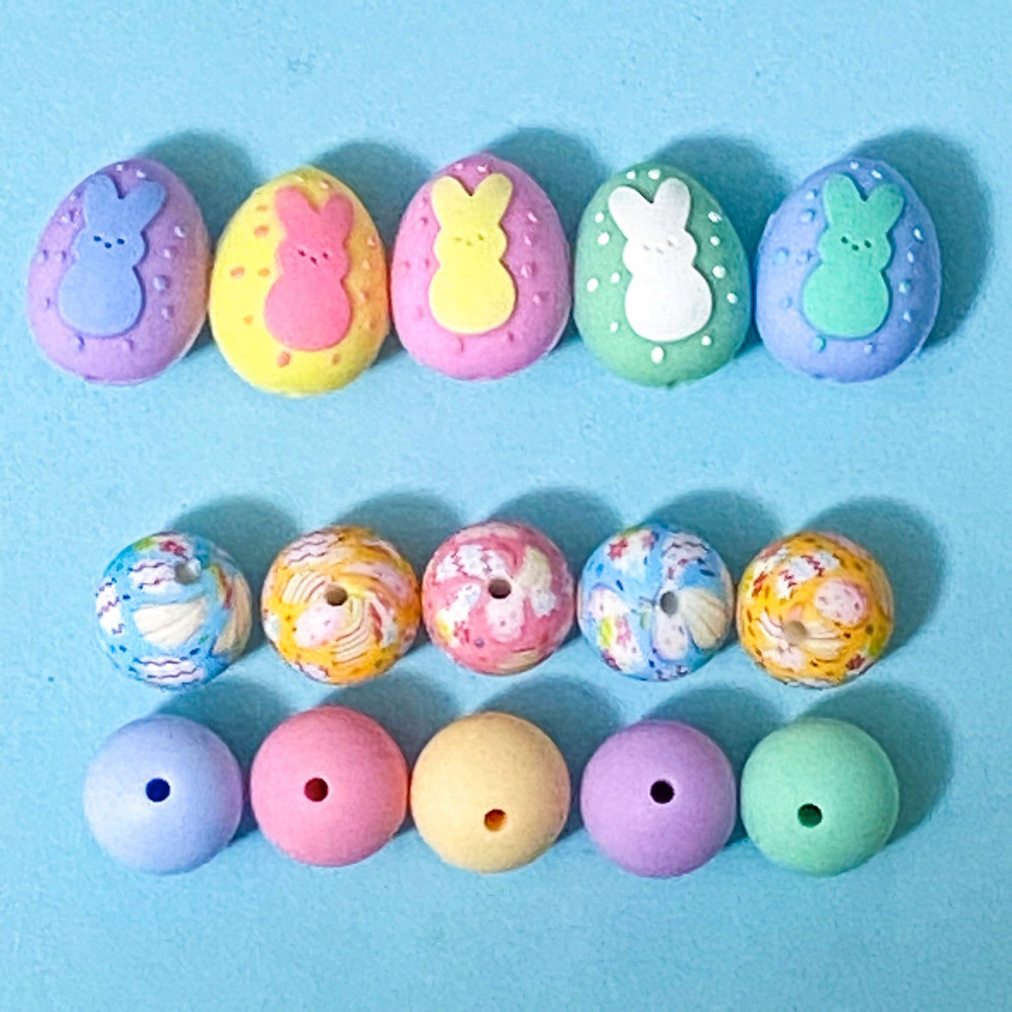 easter and spring silicone beads. a row of easter egg beads with cute rabbits on and two rows of round 16mm silicone beads in pastel colours