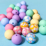 plain and patterned 16mm easter silicone round beads in pastel colours on a pale blue background