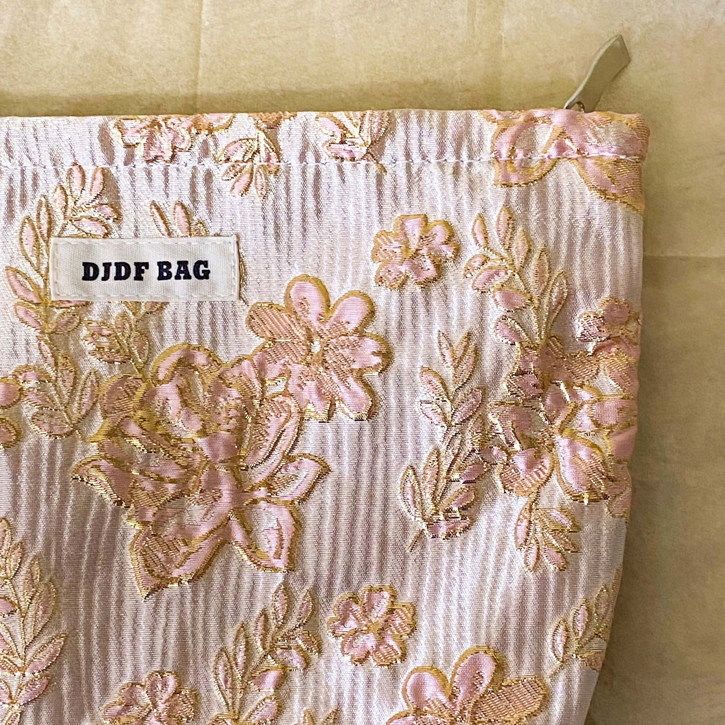 champagne satin fabric woven pouch with gold thread highlights and pink roses design. large cosmetic bag or journaling pouch. uk letterbox gifts