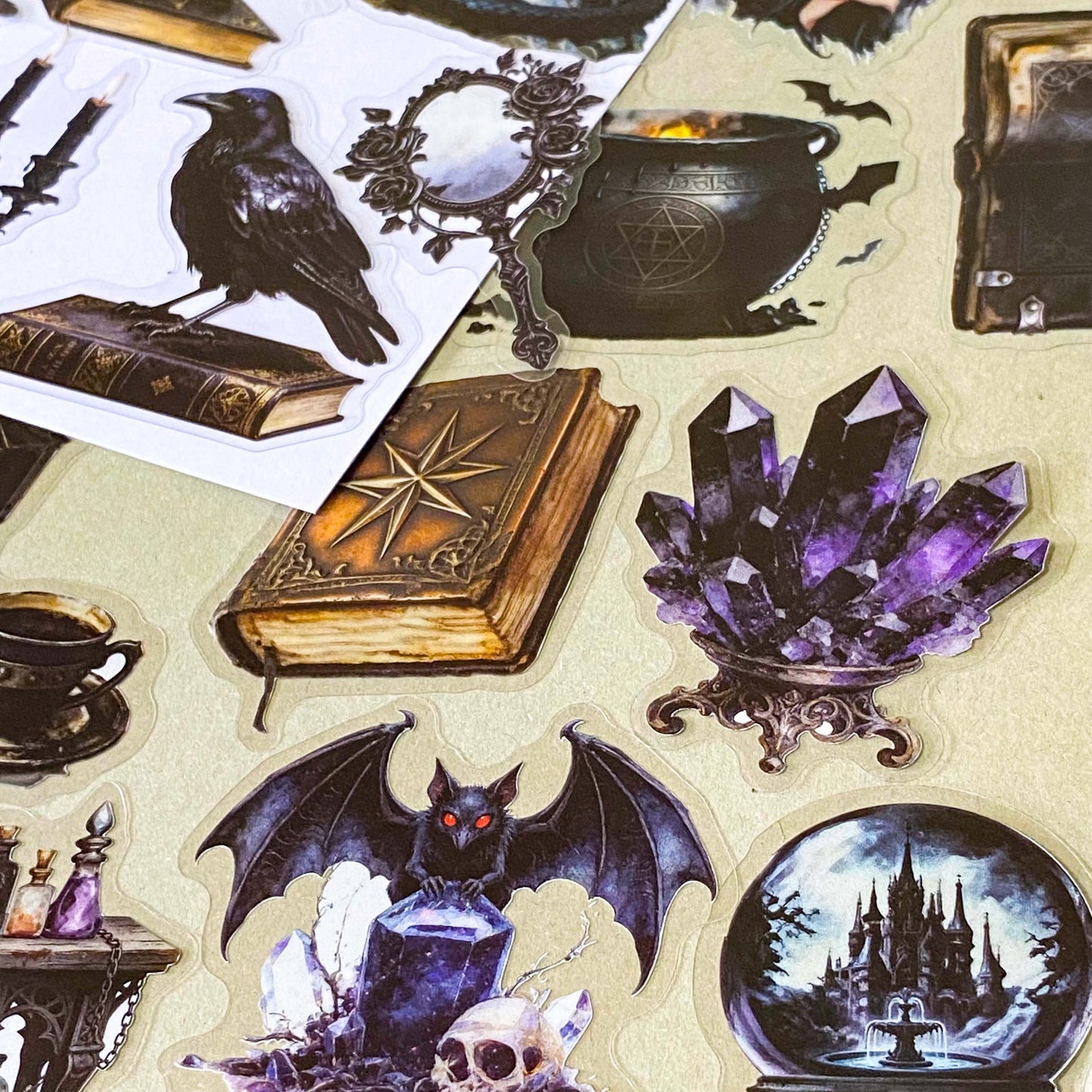 pack of 50 gothic PET stickers featuring ravens, dragons, black cats, antique books, potion bottles, crystals, witches, bats and dark academia stickers. black aesthetic. uk stationery shop.