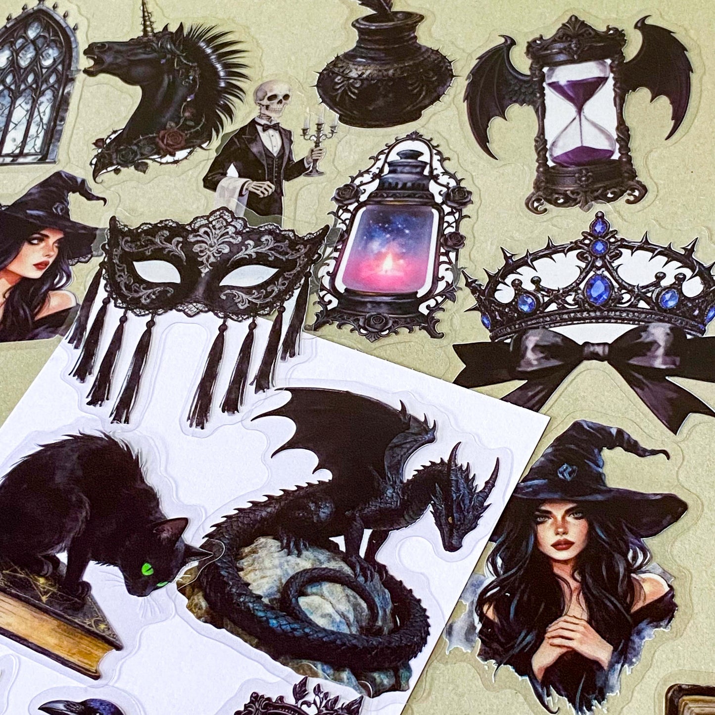 pack of 50 gothic PET stickers featuring ravens, dragons, black cats, antique books, potion bottles, crystals, witches, bats and dark academia stickers. black aesthetic. uk stationery shop.